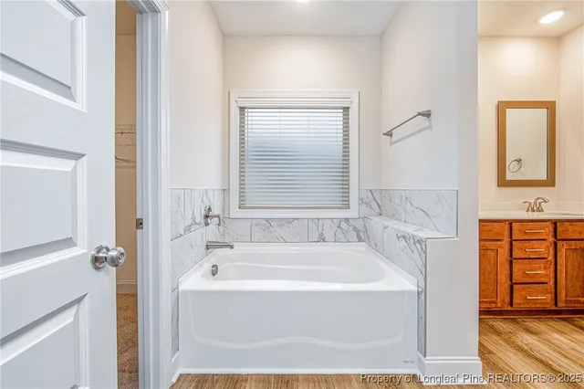 a white bath tub sitting next to a white sink