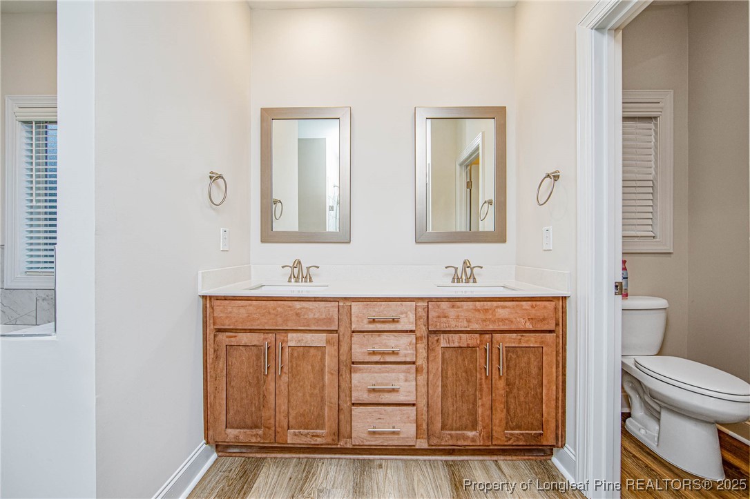 1105 Wolf Pne Court Fayetteville, NC 28311 - Photo 22 of 36 a bathroom with a sink a toilet and a mirror