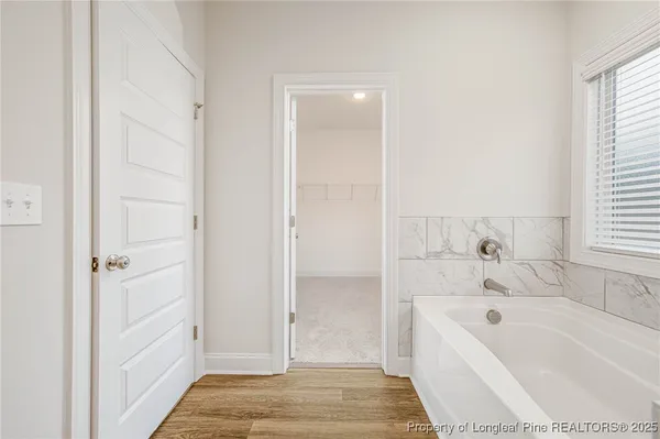 a bathroom with a tub shower and two sink