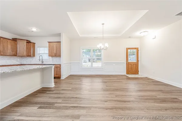 a view of a kitchen with a sink cabinets and wooden floor