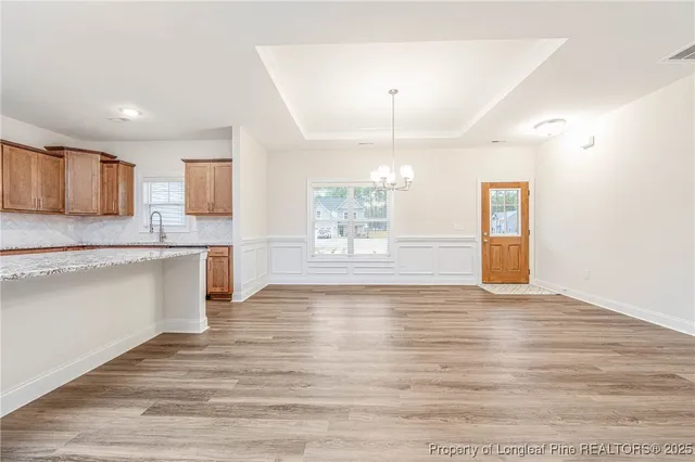 a view of a kitchen with a sink cabinets and wooden floor