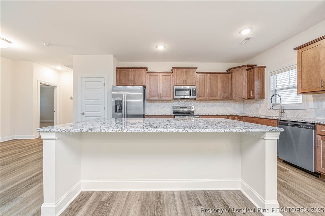 1105 Wolf Pne Court Fayetteville, NC 28311 - Photo 7 of 36 a kitchen with stainless steel appliances granite countertop a sink and a stove