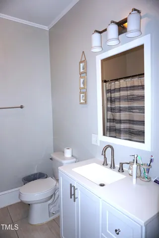 a bathroom with a sink a toilet and a window