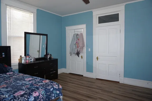 a bedroom with a bed and a dresser