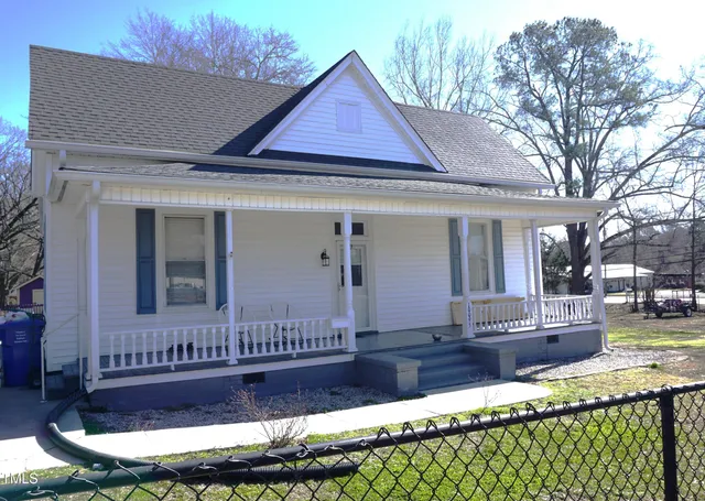 a front view of a house with a yard table and chairs