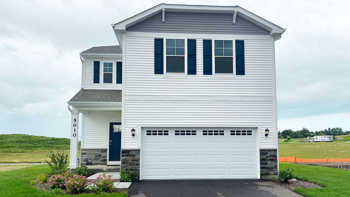 Exterior Photo of actual home with white siding and stone accents