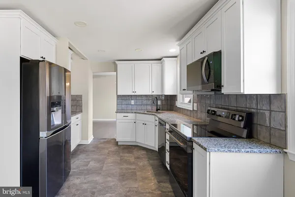 a kitchen with a sink stove and refrigerator