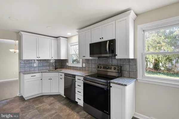 a kitchen with a sink stove and microwave