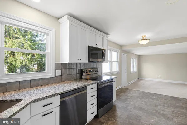 a view of a kitchen with a stove top oven