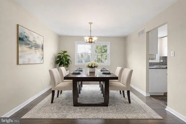 an empty room with wooden floor cabinet and windows