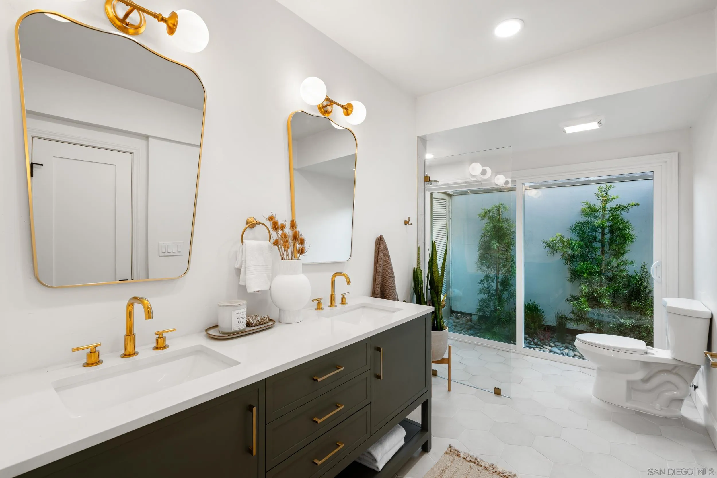 103 Cancha De Golf Rancho Santa Fe, CA 92091 - Photo 17 of 32 a bathroom with a double vanity sink mirror and toilet
