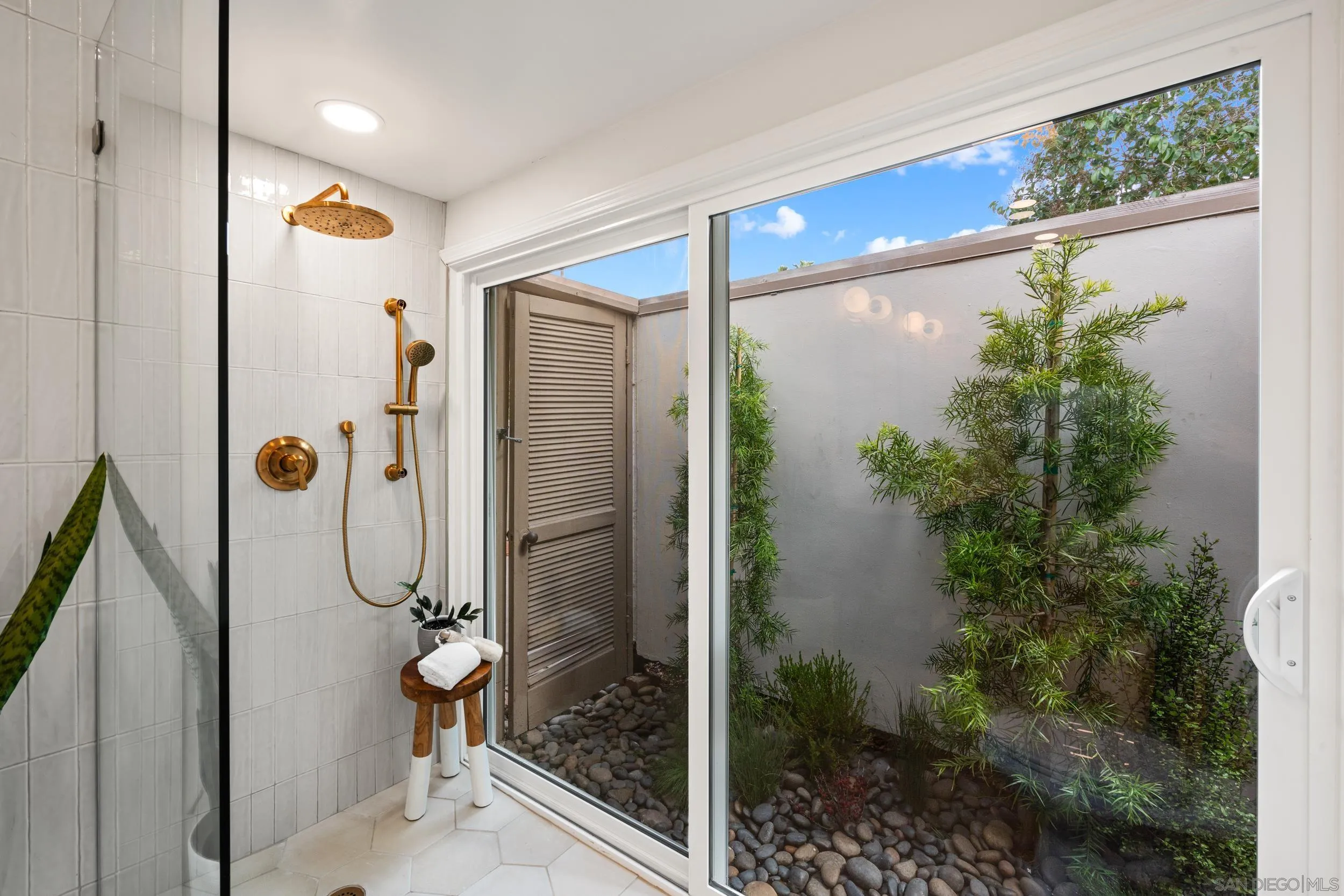 103 Cancha De Golf Rancho Santa Fe, CA 92091 - Photo 18 of 32 a bathroom with a glass shower door and a glass door