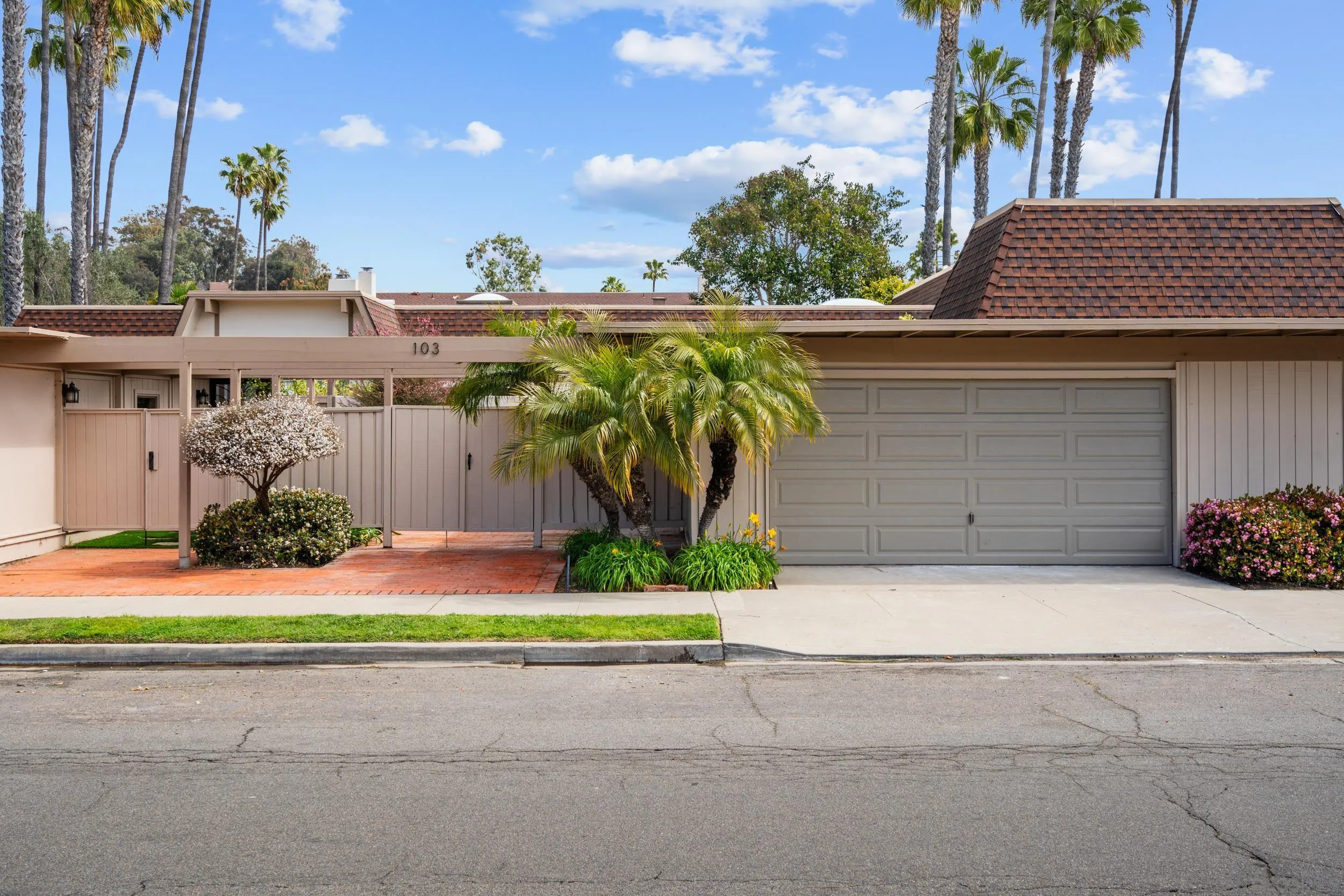 103 Cancha De Golf Rancho Santa Fe, CA 92091 - Photo 2 of 32 a front view of a house with a yard and garage