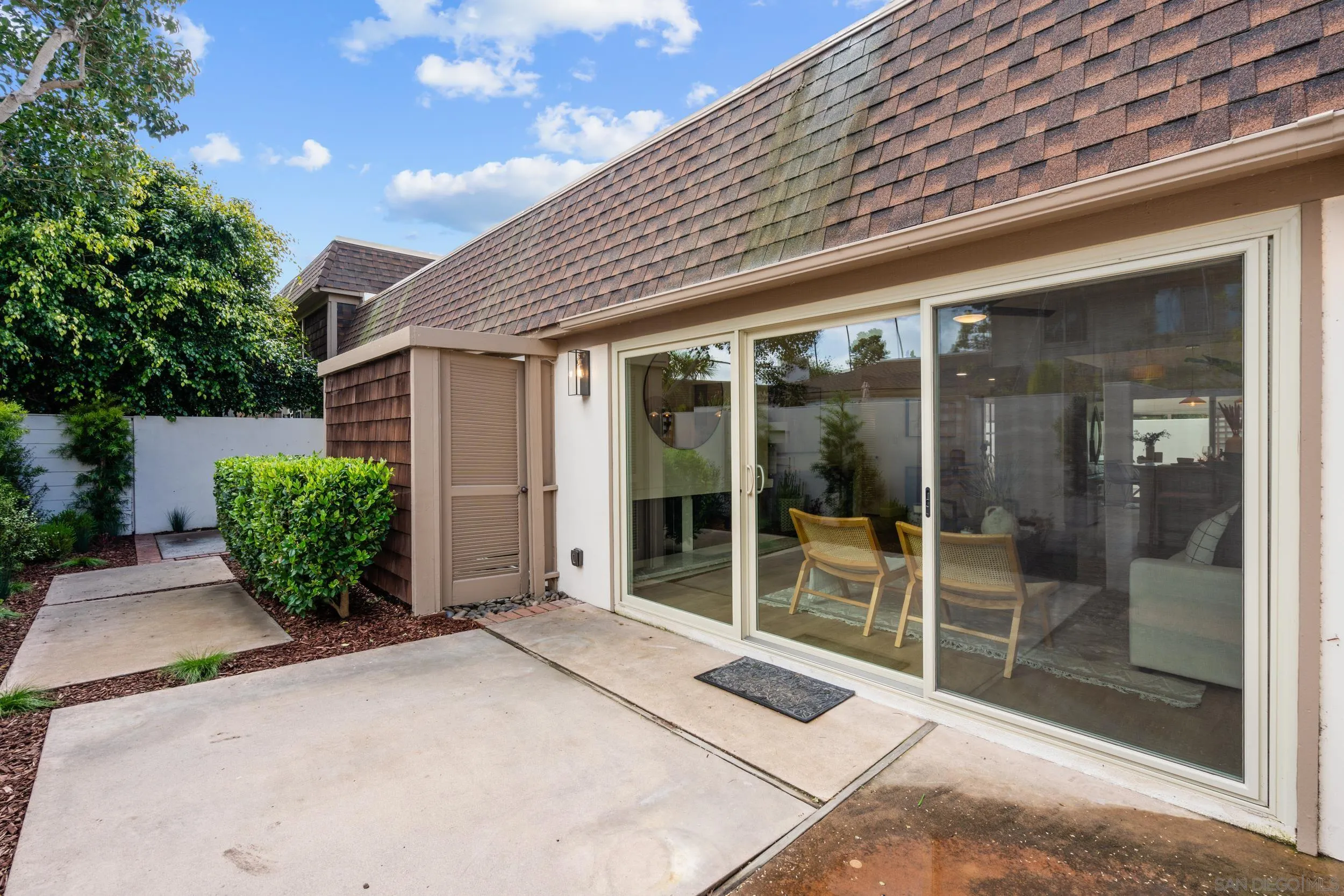 103 Cancha De Golf Rancho Santa Fe, CA 92091 - Photo 24 of 32 a front view of a house with a large window and potted plants