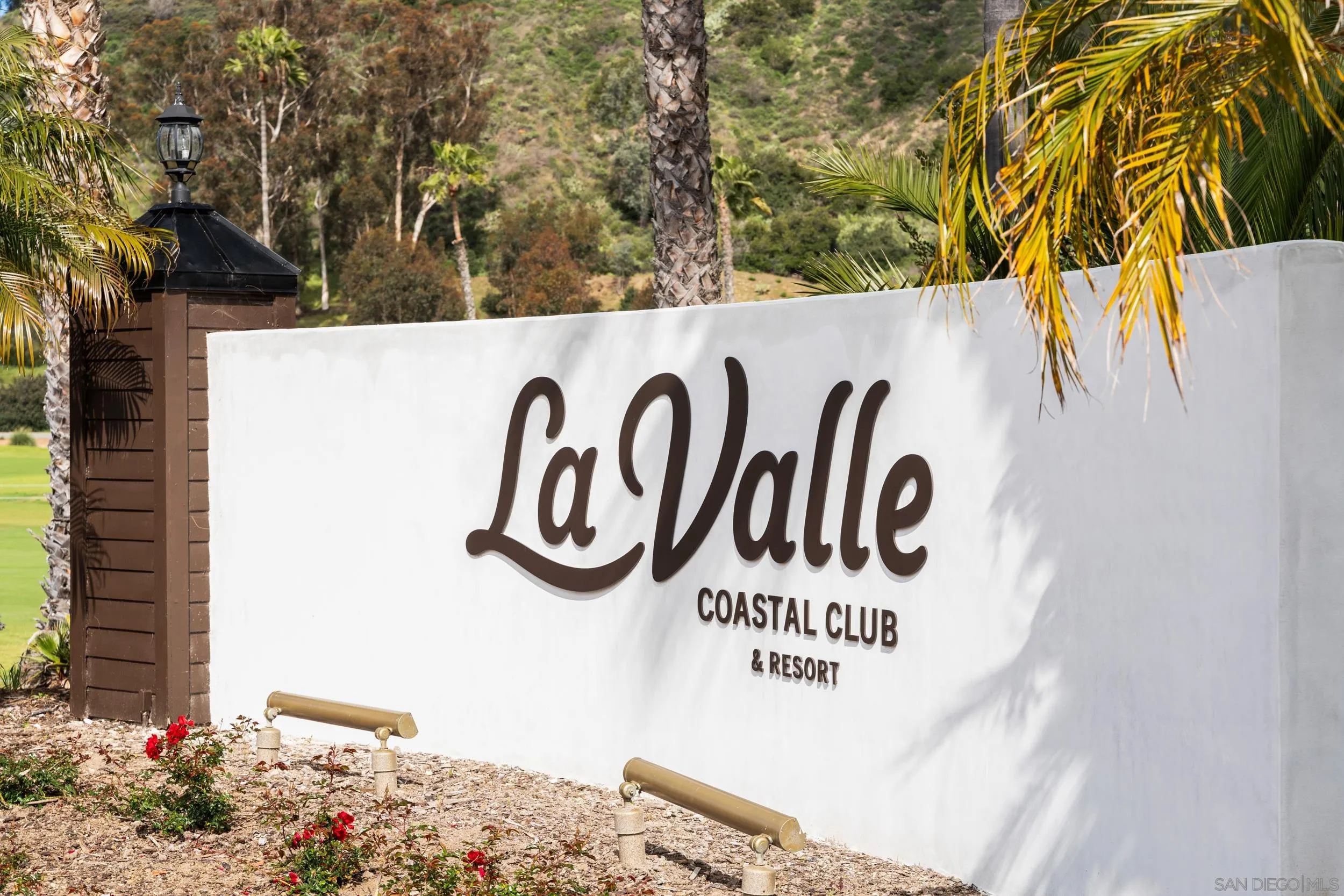 103 Cancha De Golf Rancho Santa Fe, CA 92091 - Photo 25 of 32 a sign broad on a wall under a large tree