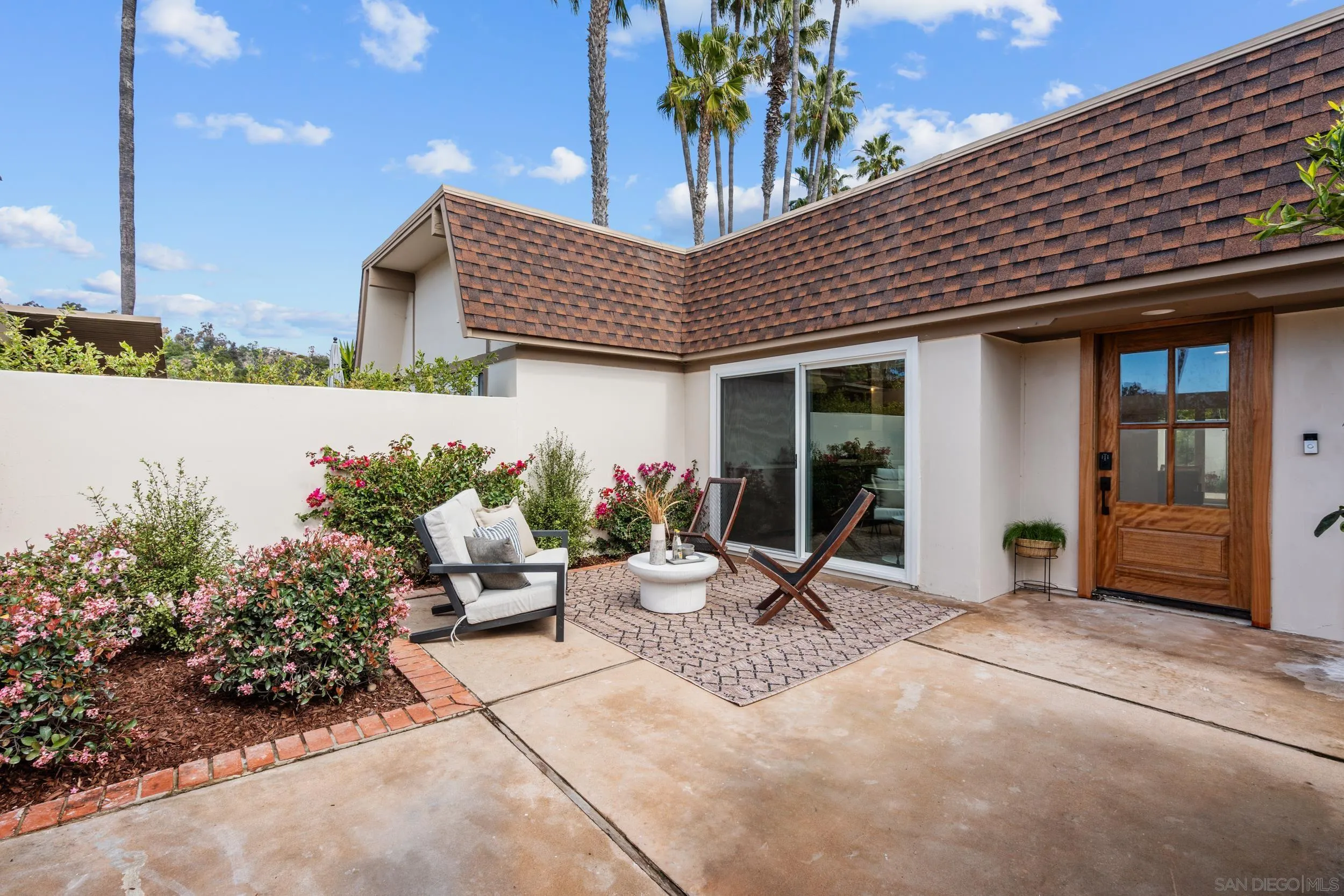 103 Cancha De Golf Rancho Santa Fe, CA 92091 - Photo 3 of 32 a building with potted plants in front of it
