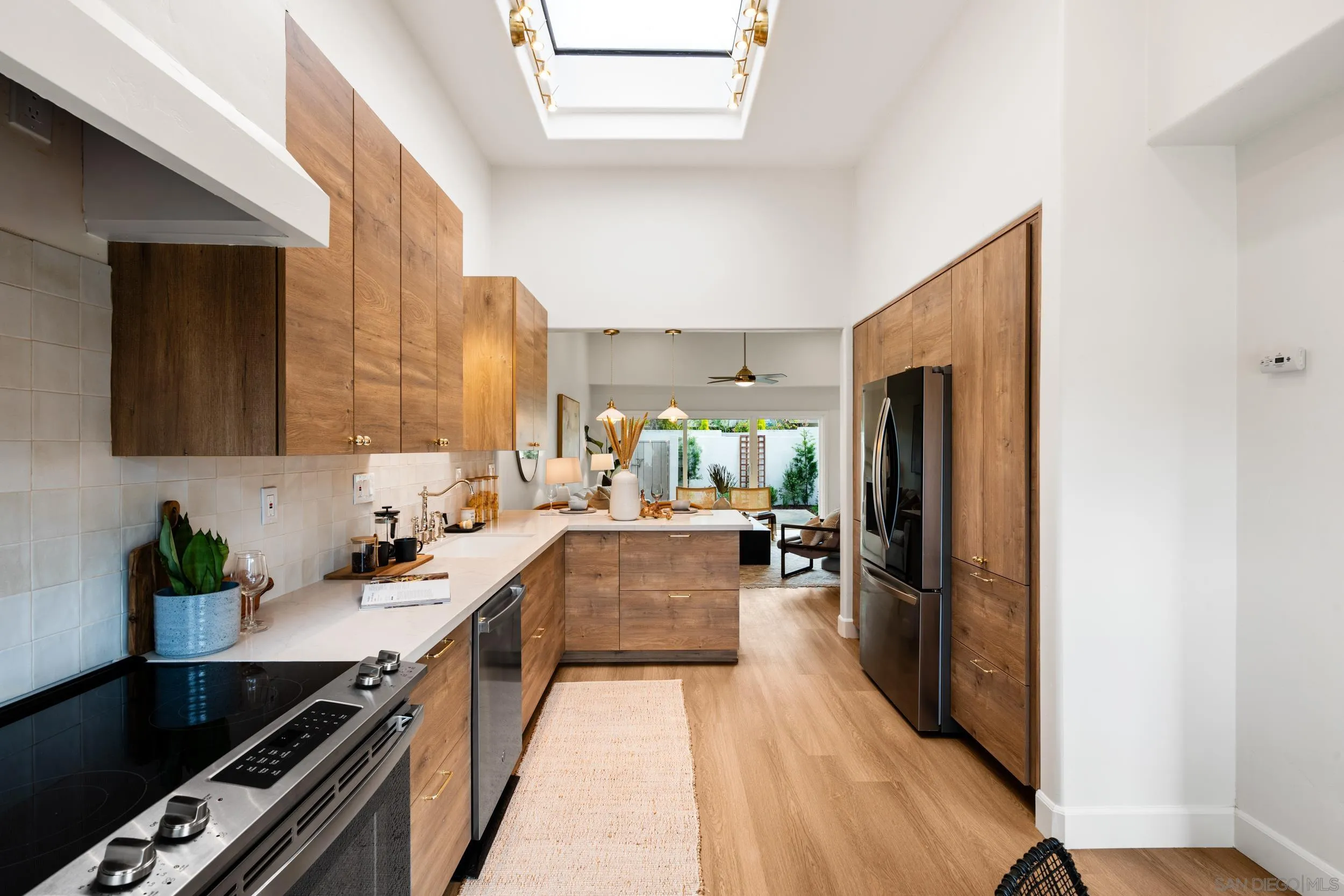 103 Cancha De Golf Rancho Santa Fe, CA 92091 - Photo 10 of 32 a kitchen with a sink stove and refrigerator