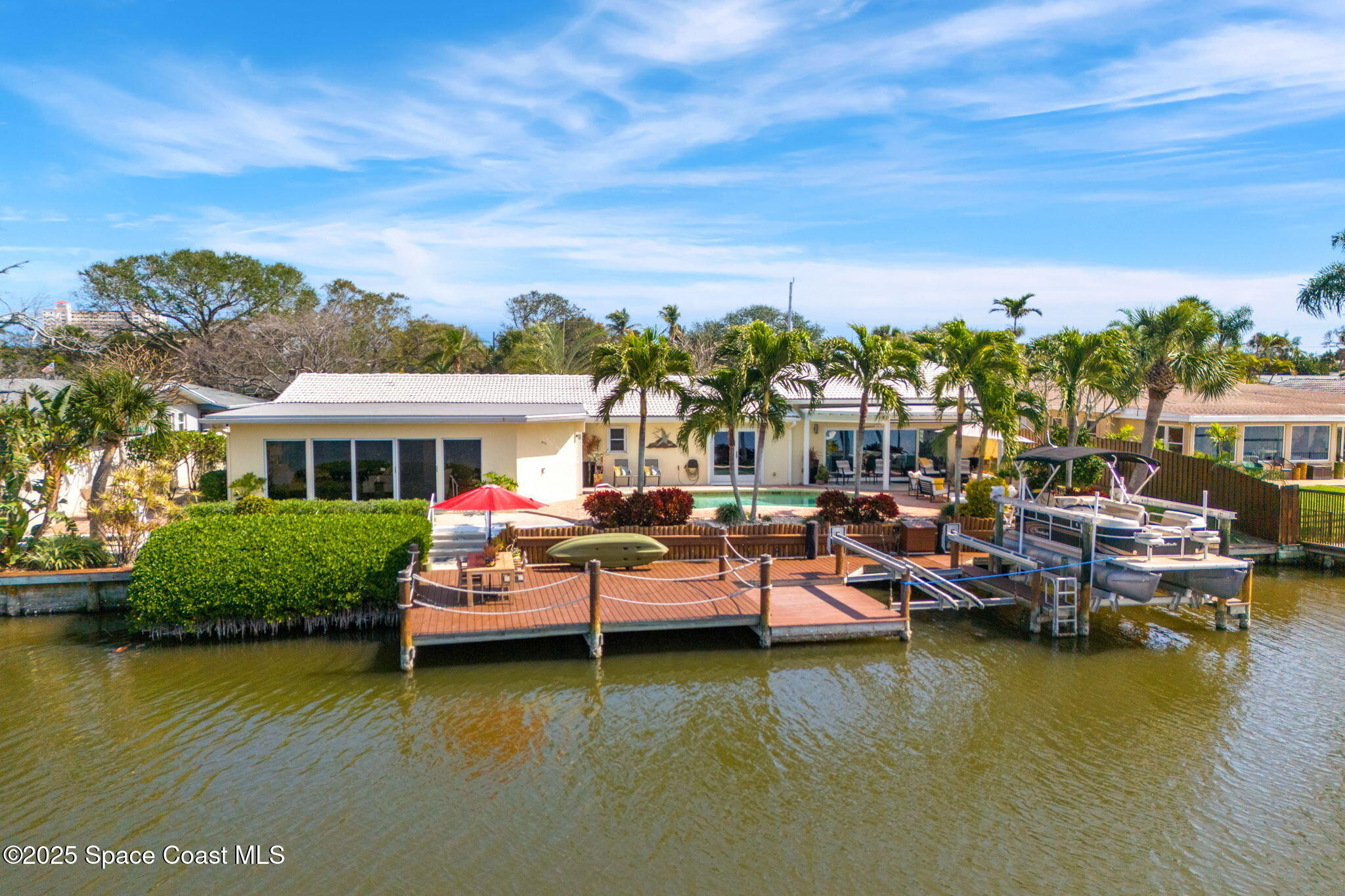 561 Capri Road Cocoa Beach, FL 32931 - Photo 15 of 82 a view of a lake with a car parked in front of it