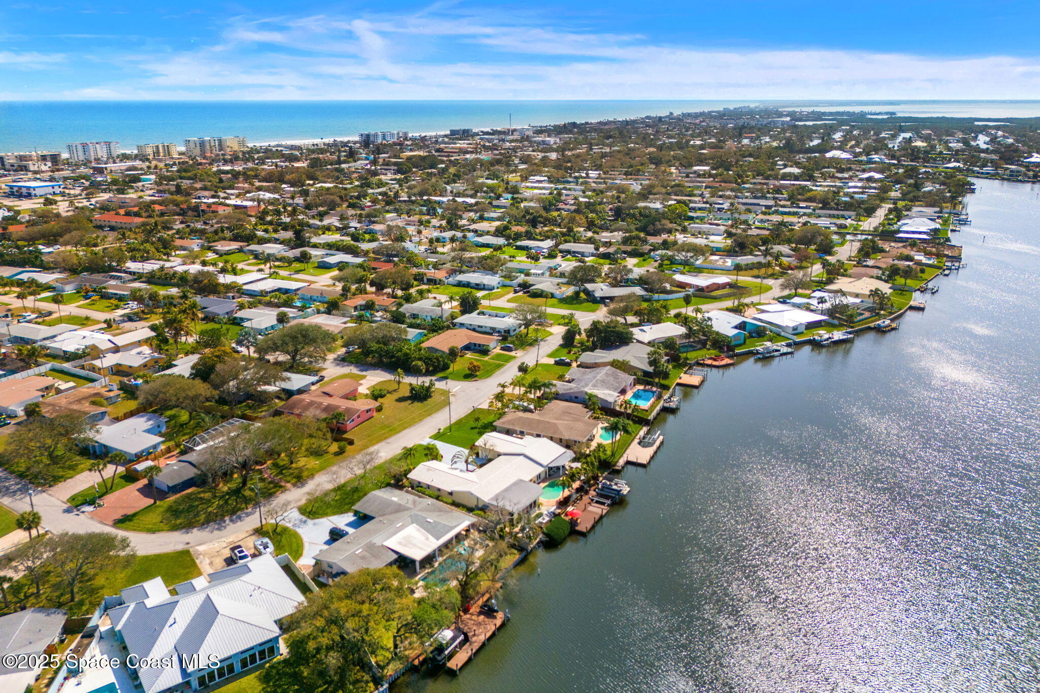 561 Capri Road Cocoa Beach, FL 32931 - Photo 16 of 82 an aerial view of city and lake