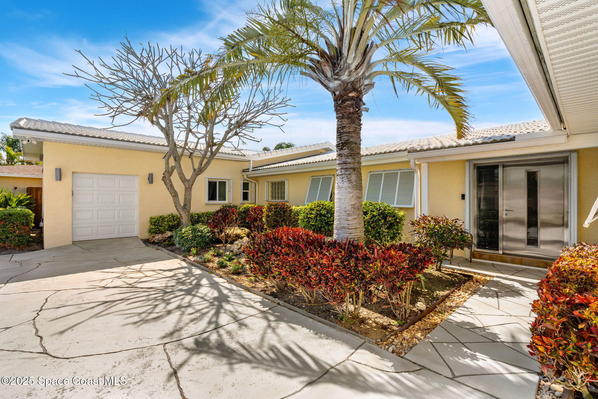 561 Capri Road Cocoa Beach, FL 32931 - Photo 20 of 82 a front view of a house with garden