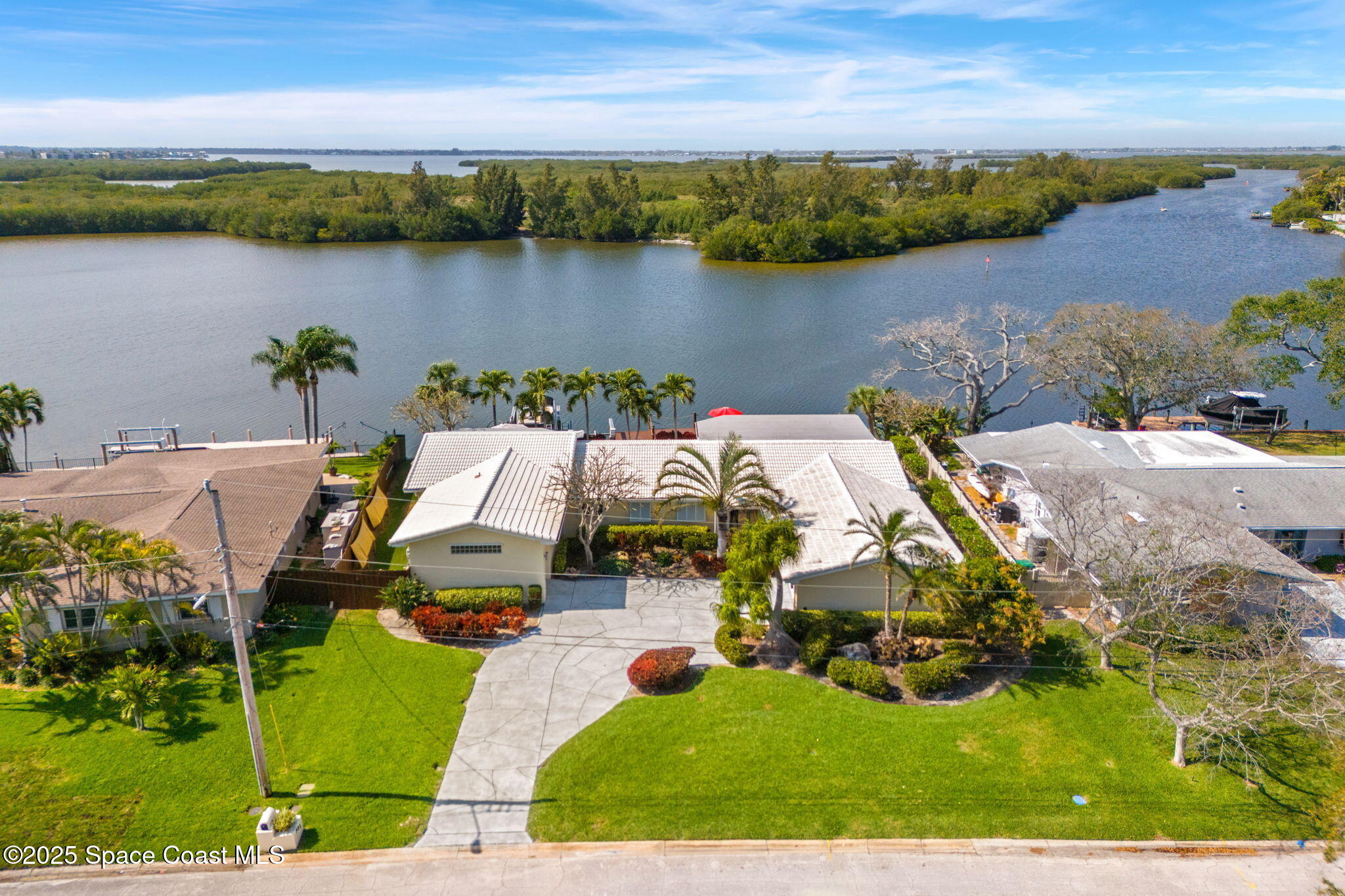 561 Capri Road Cocoa Beach, FL 32931 - Photo 2 of 82 an aerial view of a house with lake view and mountain view