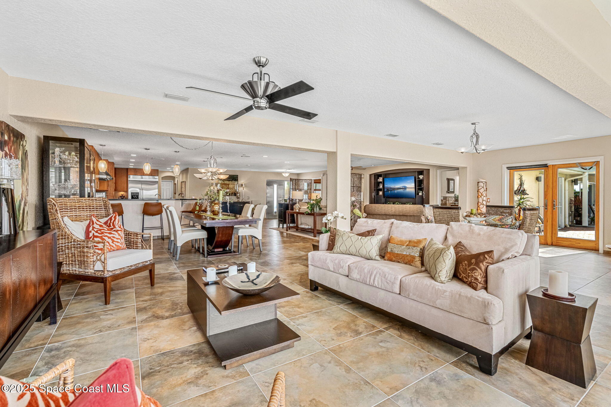 561 Capri Road Cocoa Beach, FL 32931 - Photo 27 of 82 a living room with furniture kitchen view and a fireplace
