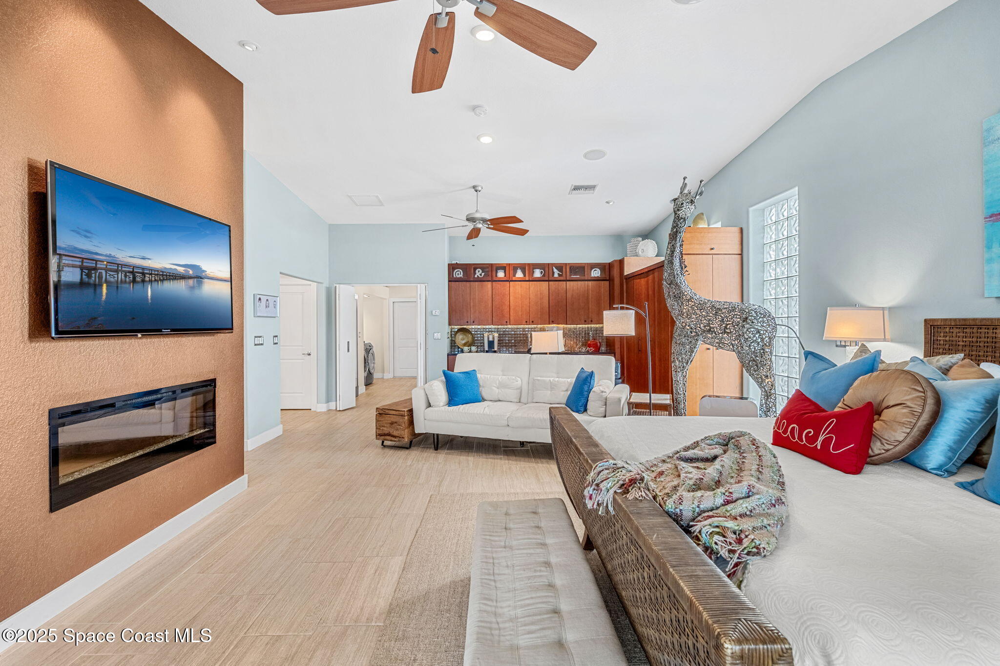 561 Capri Road Cocoa Beach, FL 32931 - Photo 37 of 82 a bedroom with furniture and a fireplace