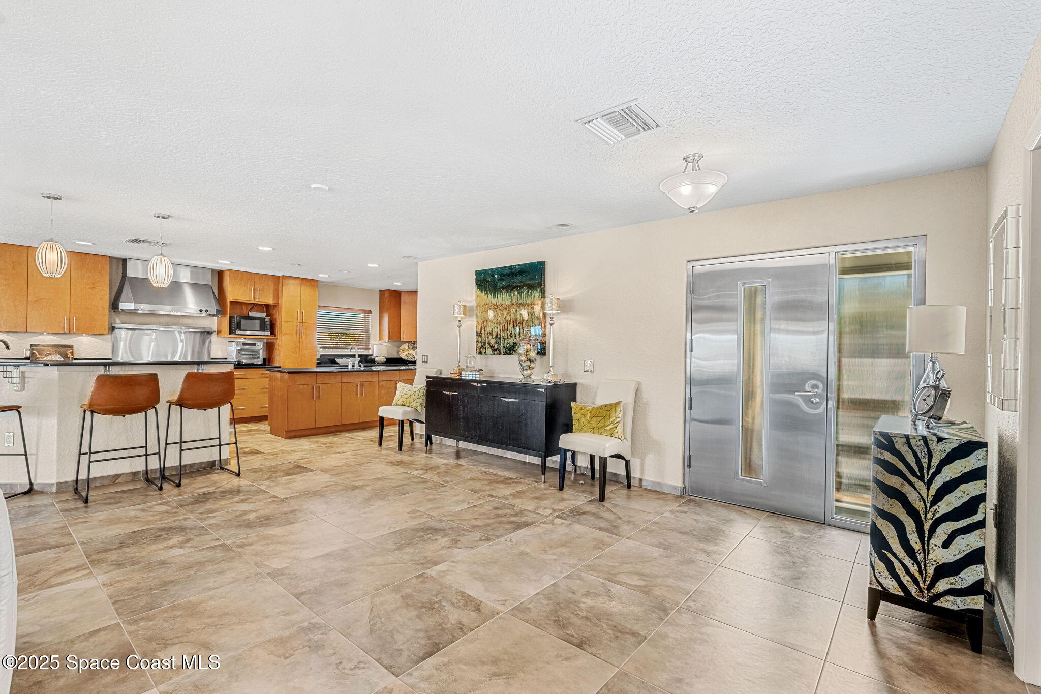 561 Capri Road Cocoa Beach, FL 32931 - Photo 4 of 82 a living room with furniture and kitchen view