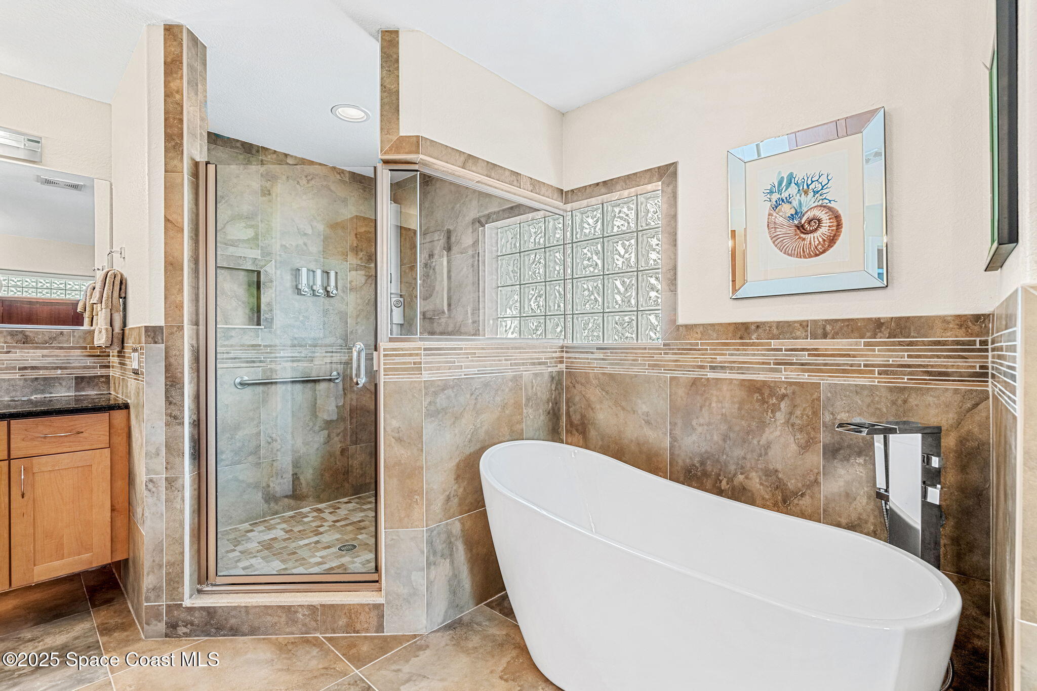 561 Capri Road Cocoa Beach, FL 32931 - Photo 43 of 82 a bathroom with a bathtub and shower