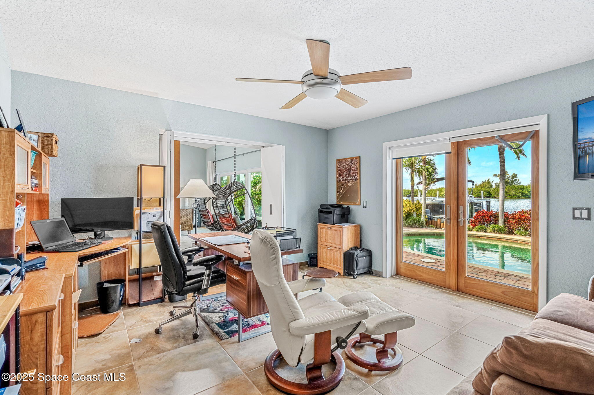 561 Capri Road Cocoa Beach, FL 32931 - Photo 46 of 82 a view of a livingroom with workspace and a window