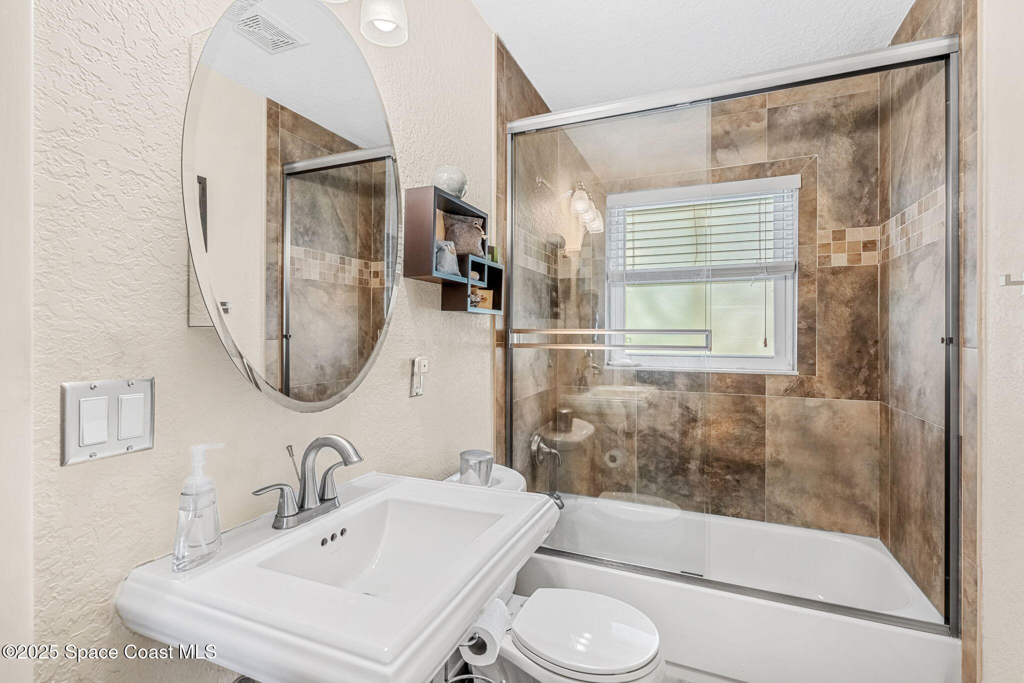 561 Capri Road Cocoa Beach, FL 32931 - Photo 48 of 82 a bathroom with a sink toilet and shower