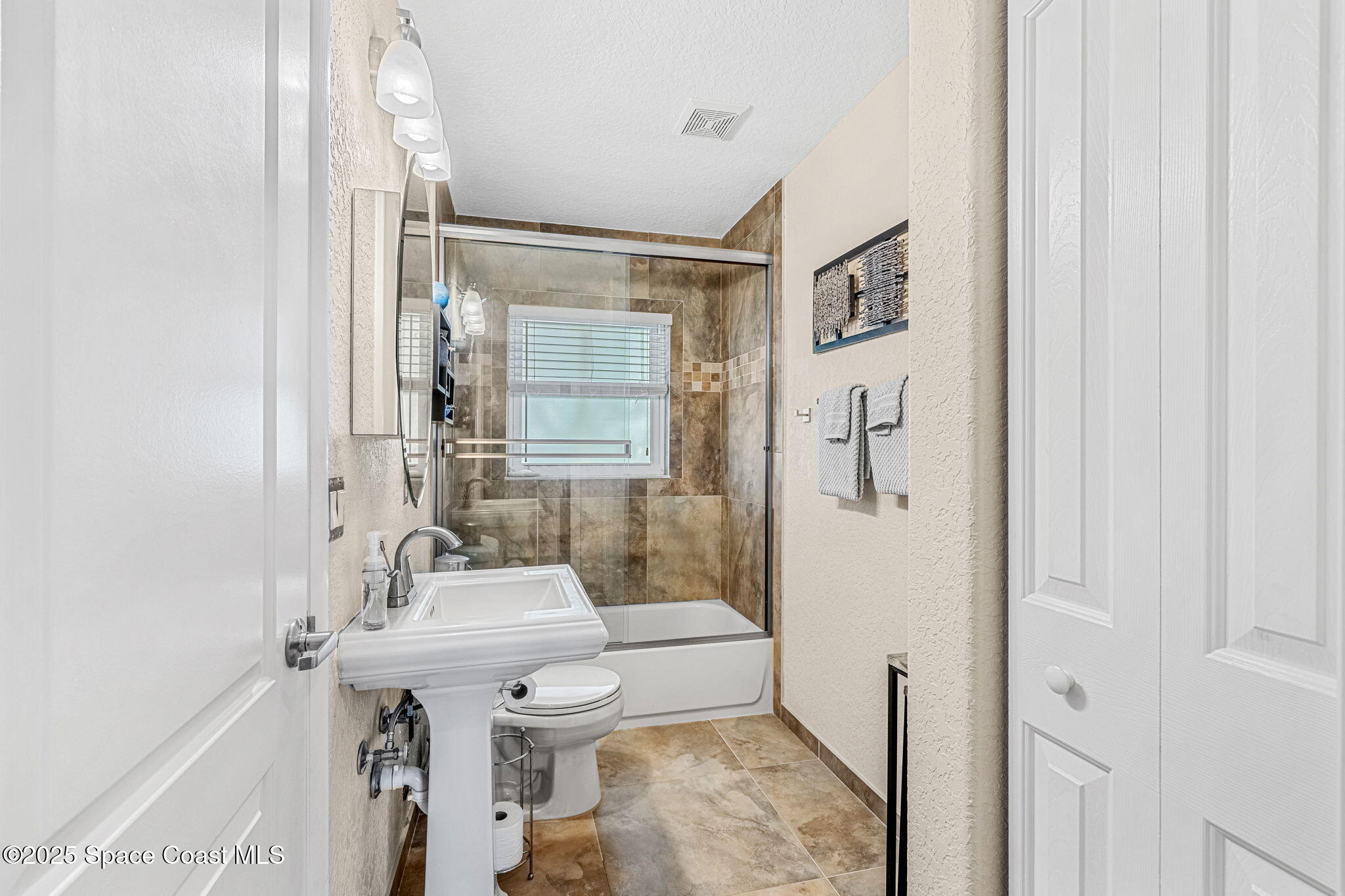 561 Capri Road Cocoa Beach, FL 32931 - Photo 49 of 82 a bathroom with a sink and a mirror