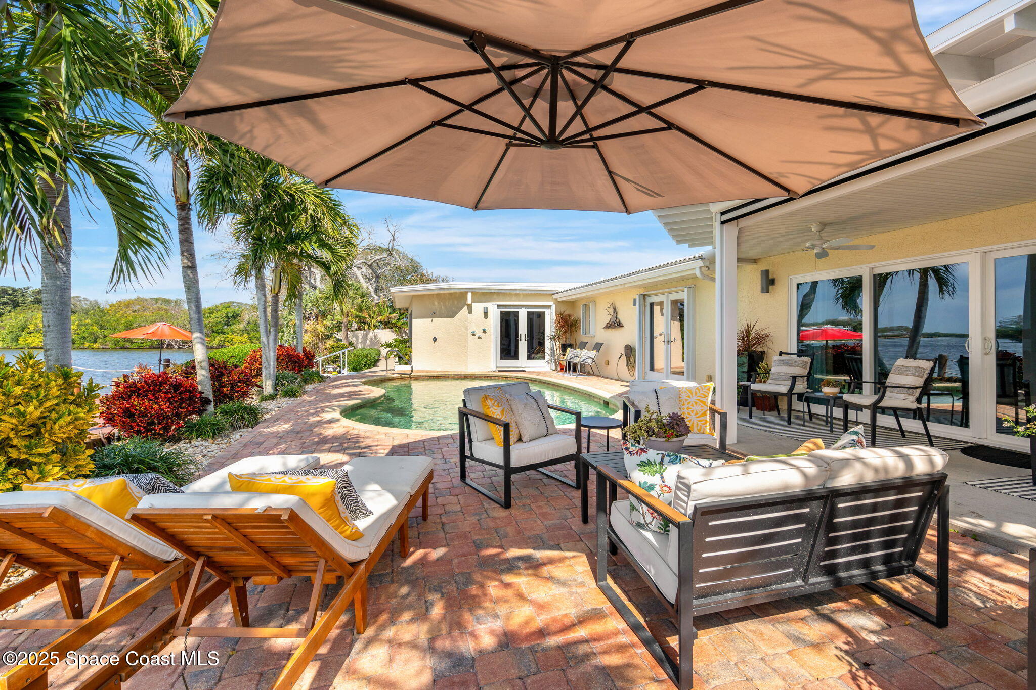 561 Capri Road Cocoa Beach, FL 32931 - Photo 58 of 82 a view of a patio with swimming pool