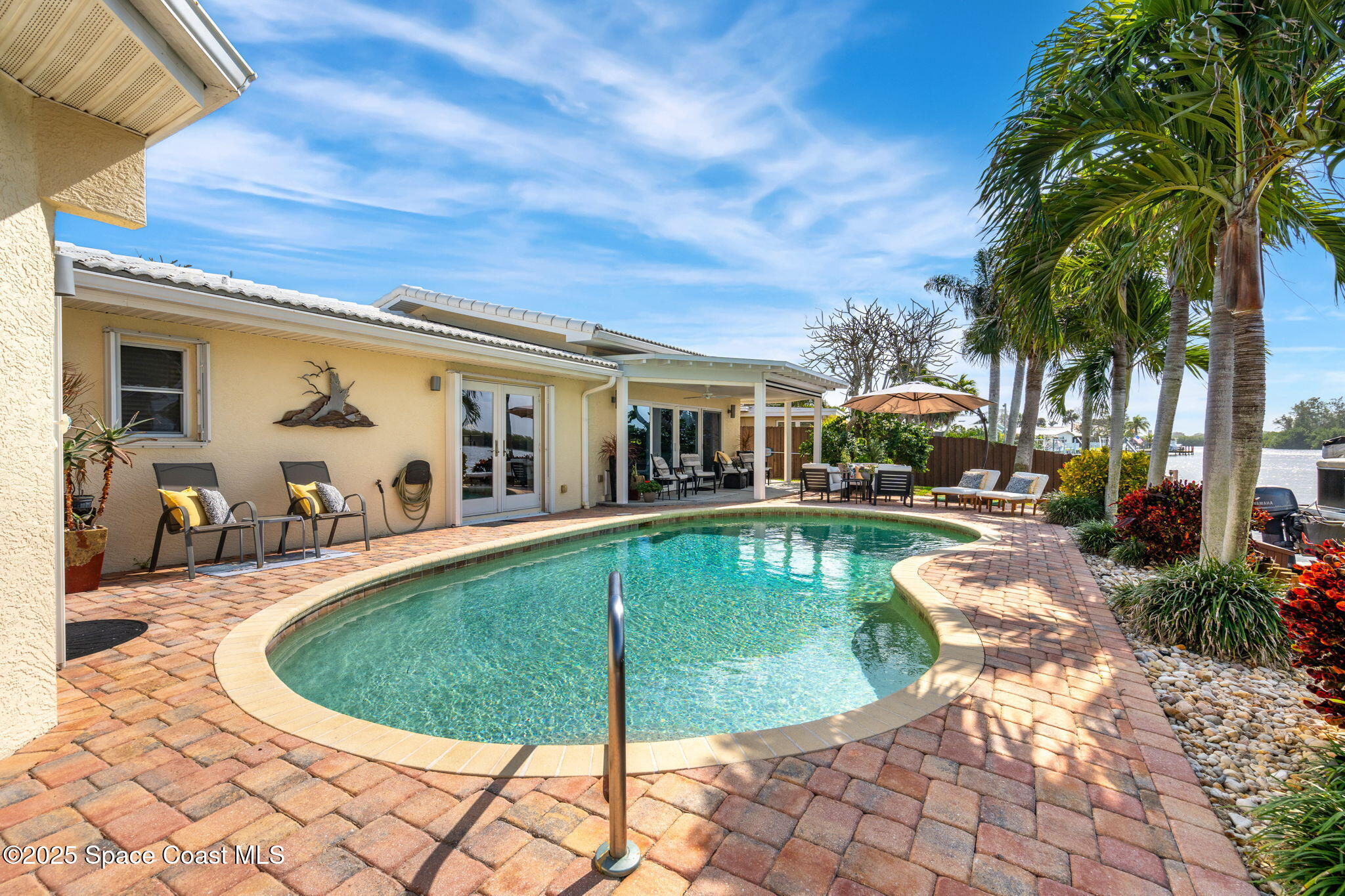 561 Capri Road Cocoa Beach, FL 32931 - Photo 61 of 82 a view of a swimming pool with a patio