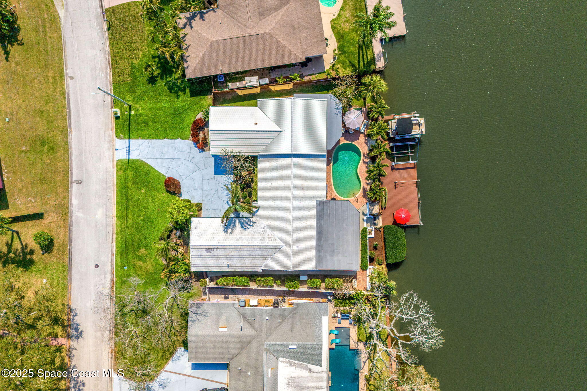 561 Capri Road Cocoa Beach, FL 32931 - Photo 75 of 82 an aerial view of a house with a yard and fountain