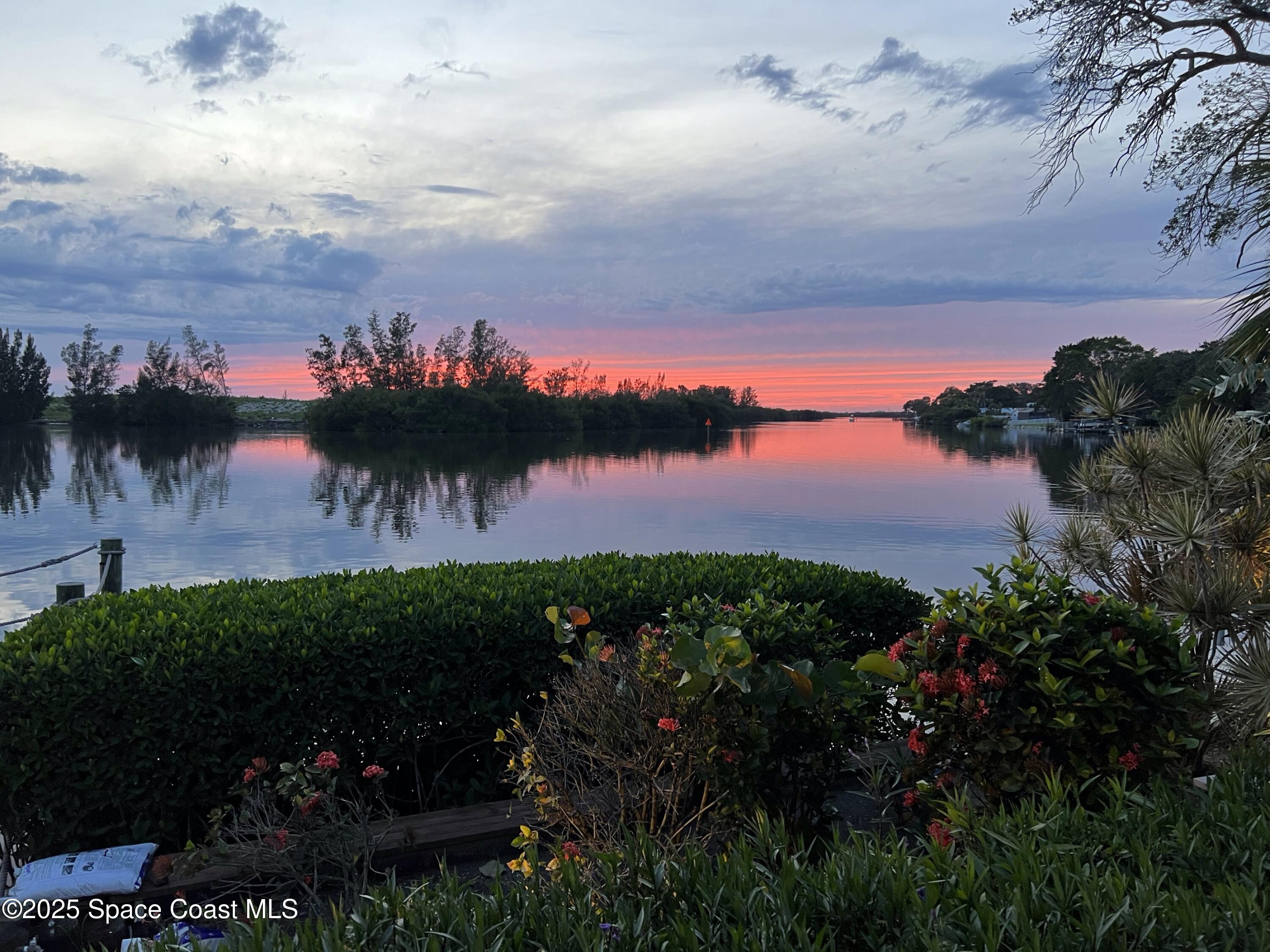 561 Capri Road Cocoa Beach, FL 32931 - Photo 76 of 82 a view of a lake from a yard