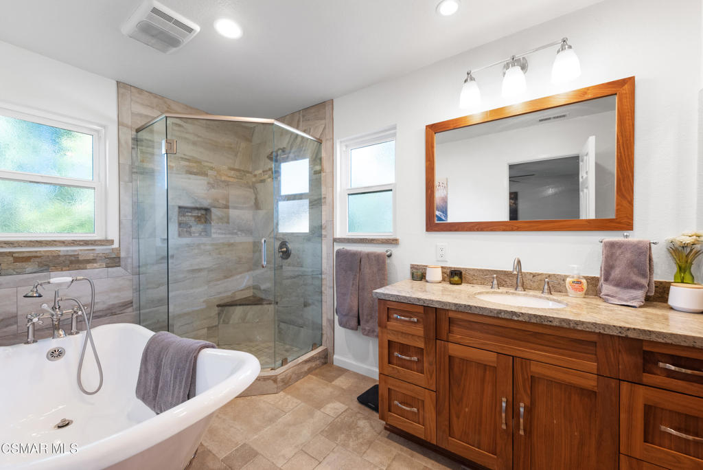 683 Languid Lane Simi Valley, CA 93065 - Photo 12 of 27 a bathroom with a tub a sink double vanity and mirror