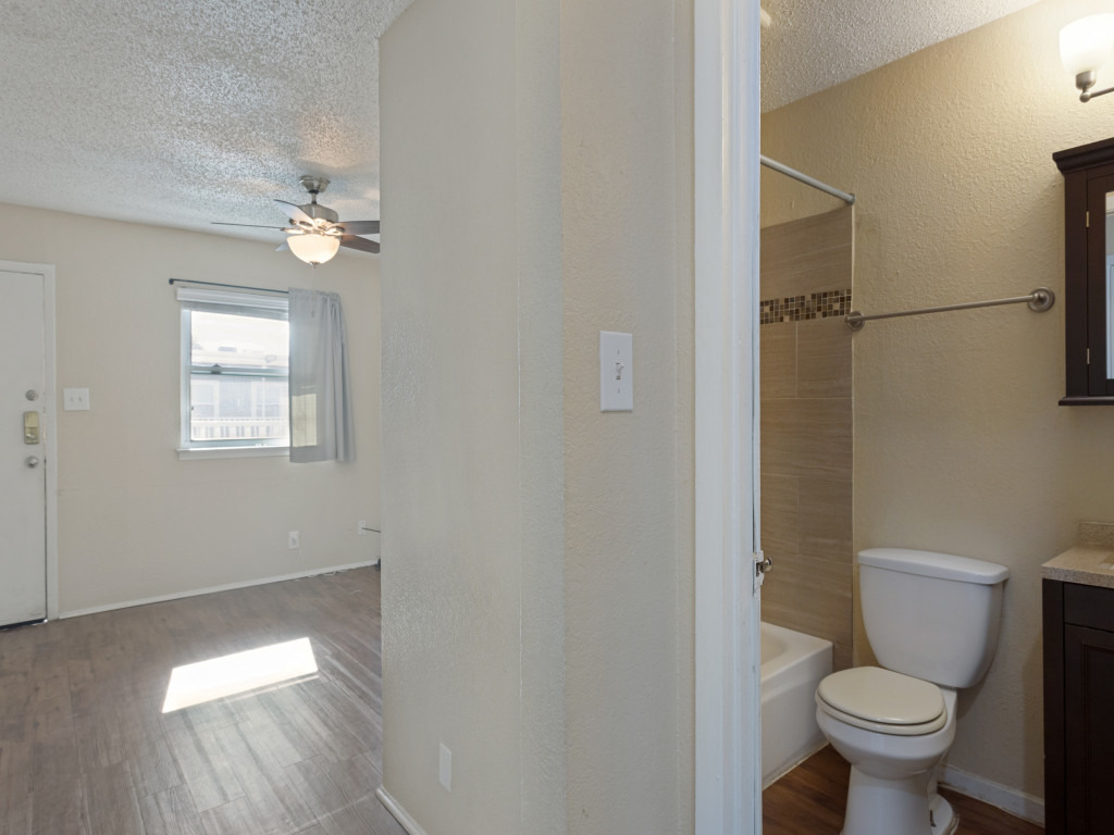 2401 Manor Road, Unit 218 Austin, TX 78722 - Photo 27 of 27 This living space provides a comfortable atmosphere with a well-maintained bathroom conveniently adjacent.