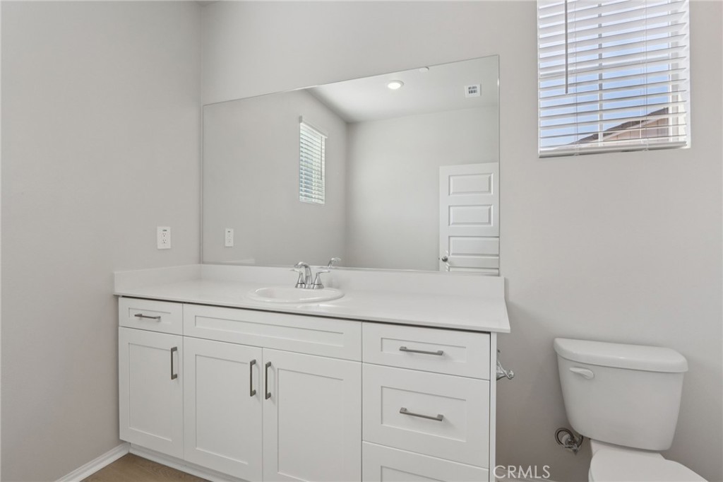 1110 Tropic Court Redlands, CA 92374 - Photo 27 of 44 a bathroom with a toilet sink and mirror