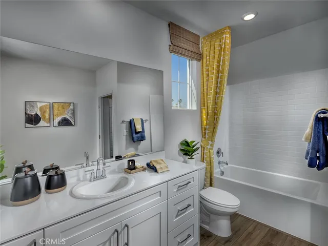 a bathroom with a double vanity sink toilet and mirror