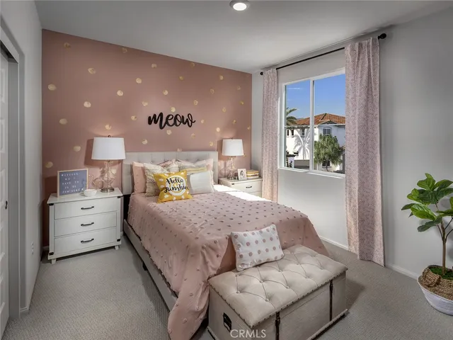 a bedroom with a bed and a potted plant