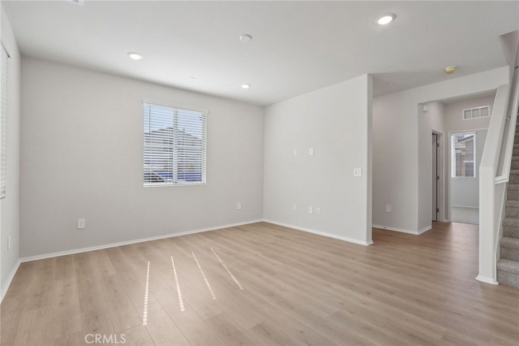1110 Tropic Court Redlands, CA 92374 - Photo 7 of 44 an empty room with wooden floor and windows