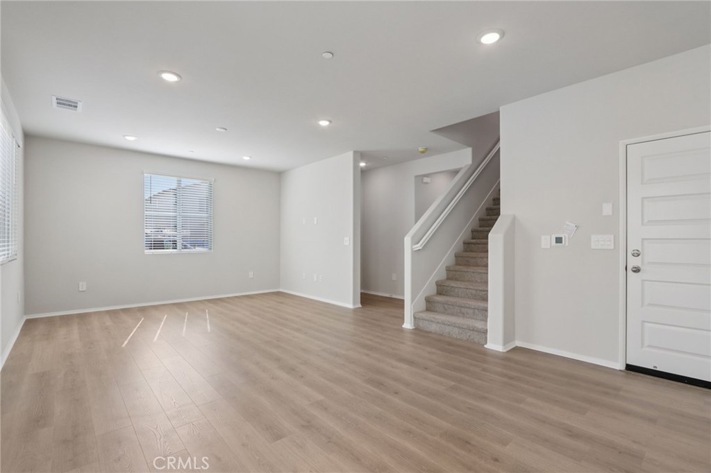1110 Tropic Court Redlands, CA 92374 - Photo 10 of 44 a view of an empty room with wooden floor and a window