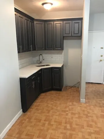 a kitchen with a sink and cabinets