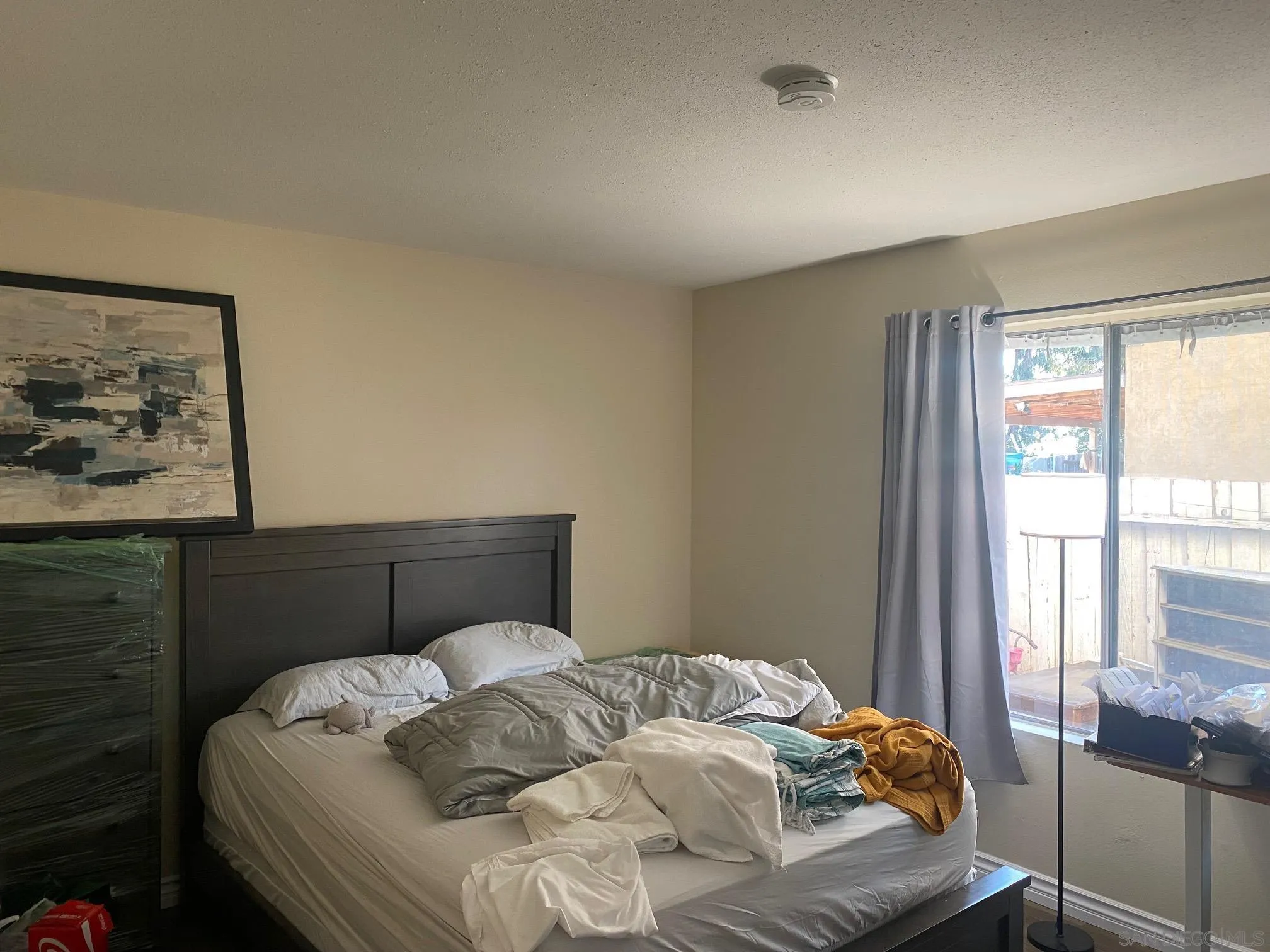 8181 Jade Coast Road San Diego, CA 92126 - Photo 5 of 9 a bedroom with a bed and a window