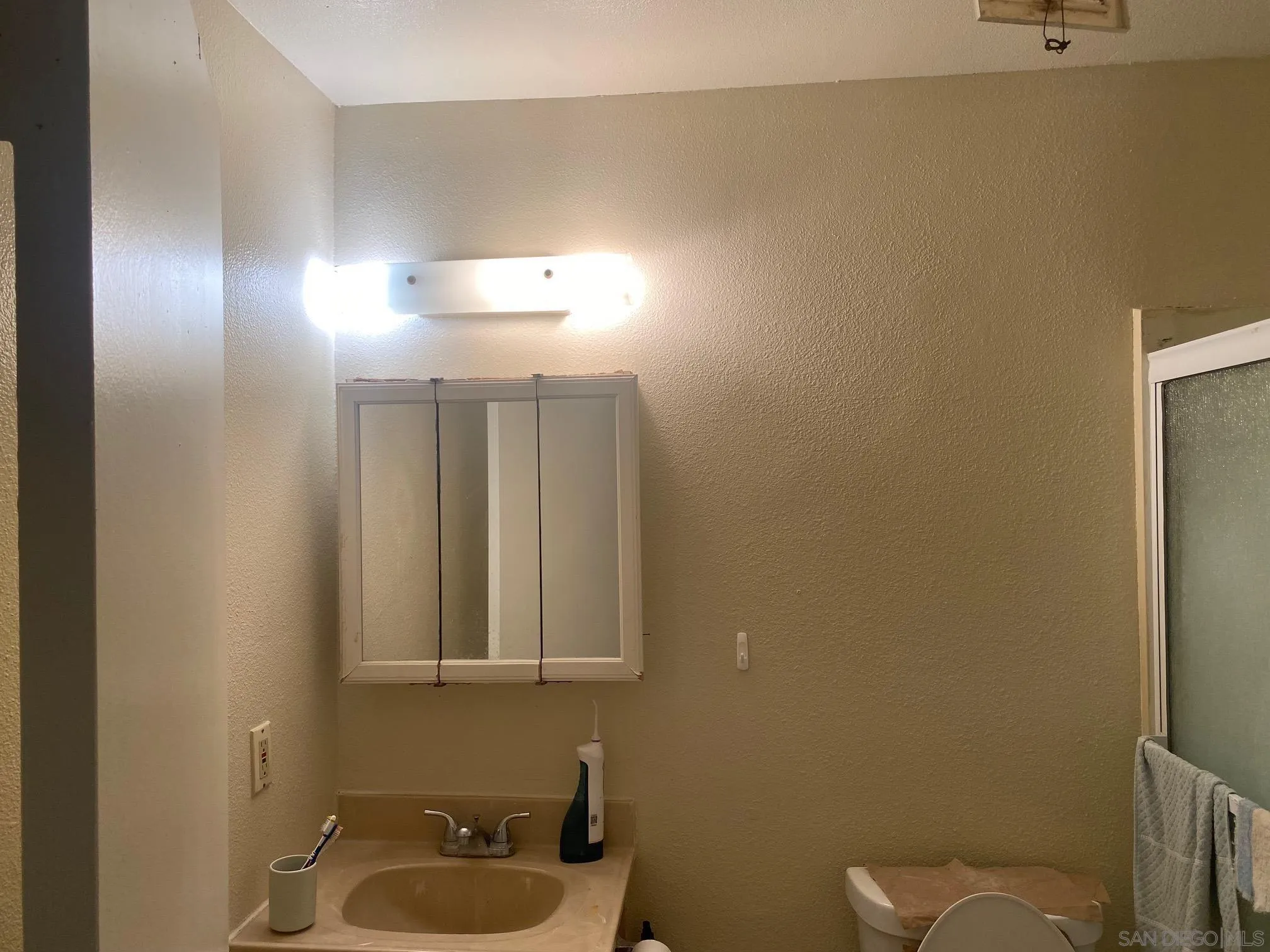 8181 Jade Coast Road San Diego, CA 92126 - Photo 8 of 9 a bathroom with a sink a toilet and a mirror