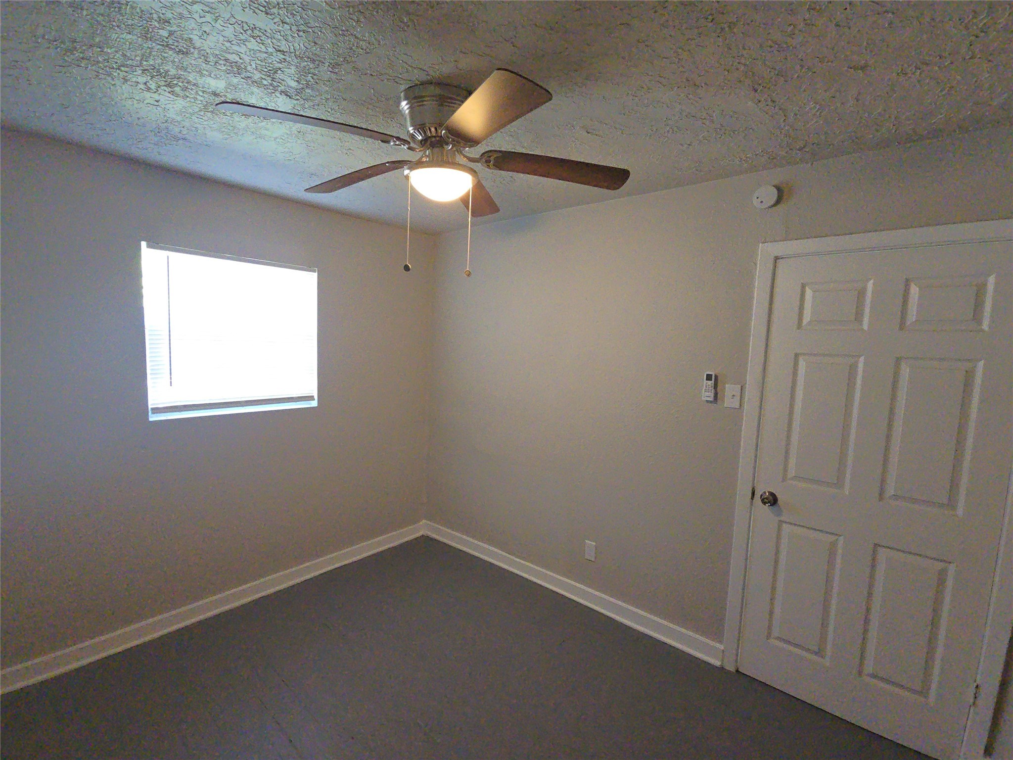 3335 Tuam Street, Unit 2 Houston, TX 77004 - Photo 8 of 15 an empty room with a window and a fan