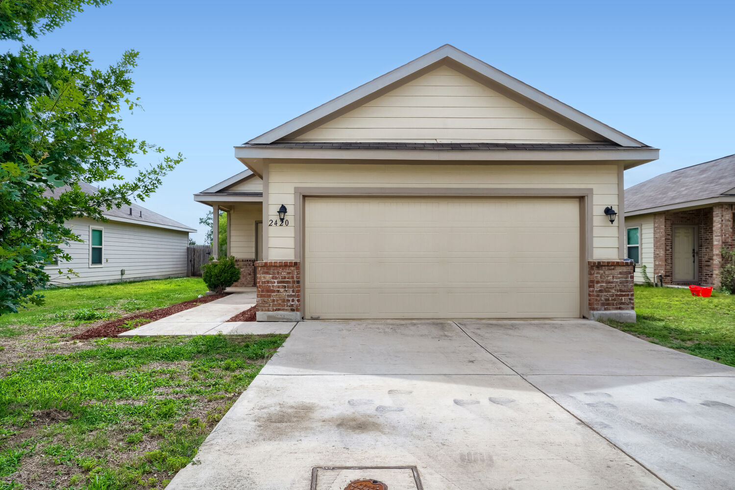 2420 Ranger Pass Seguin, TX 78155 - Photo 1 of 28 Single-story residence featuring a two-car garage, brick accents, and a covered entry