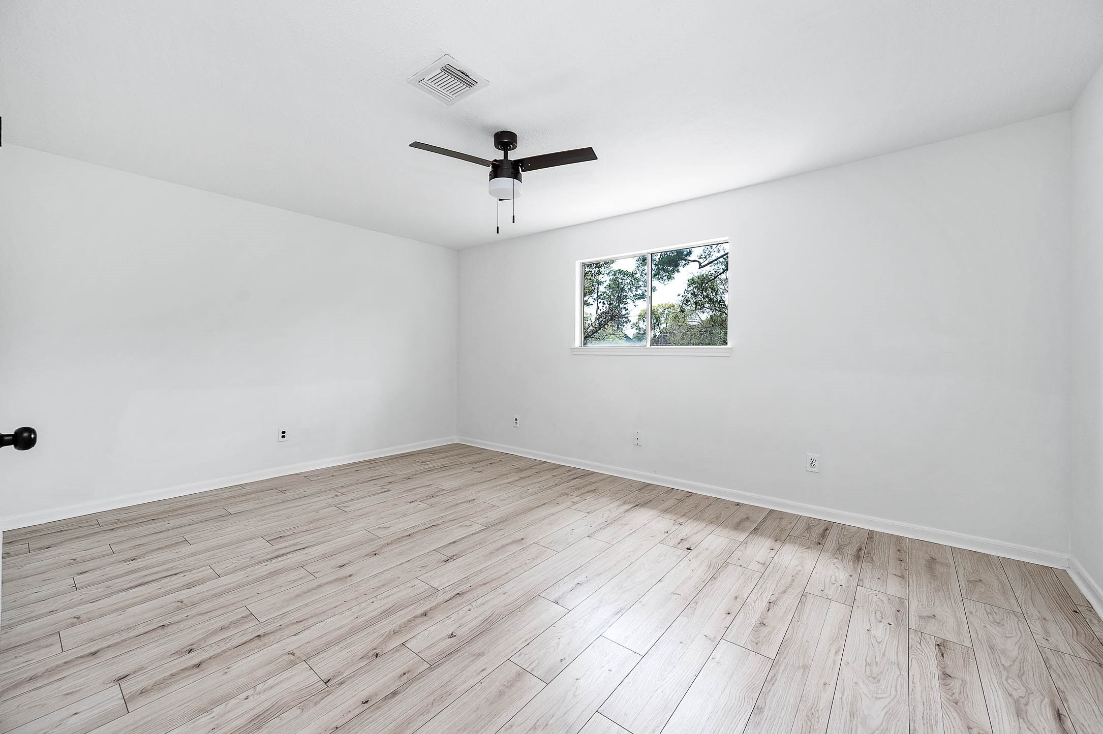 17627 Terrawren Lane Spring, TX 77379 - Photo 25 of 30 an empty room with wooden floor and windows