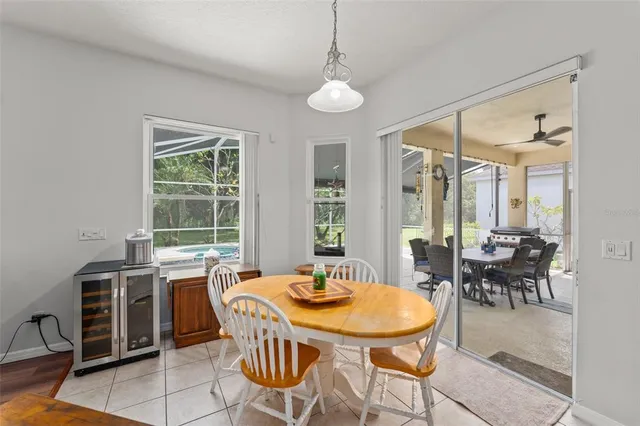 a dining room with furniture a chandelier and a rug